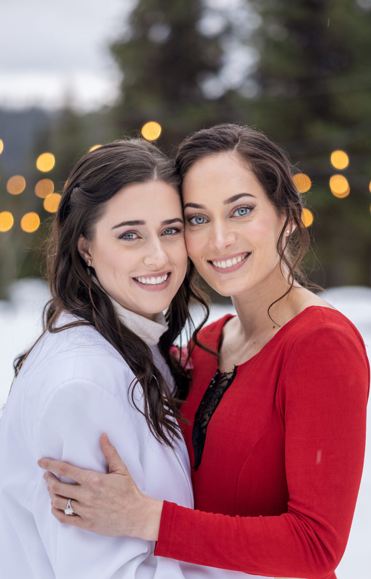 two women smile at the camera during a winter elopement